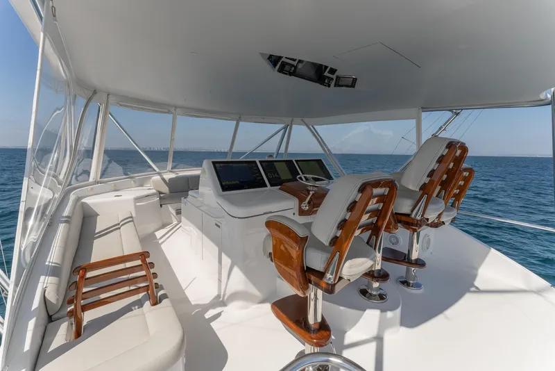 Slide: The Image of 2018 Hatteras GT70 yacht helm with luxurious seating and ocean view. - 13