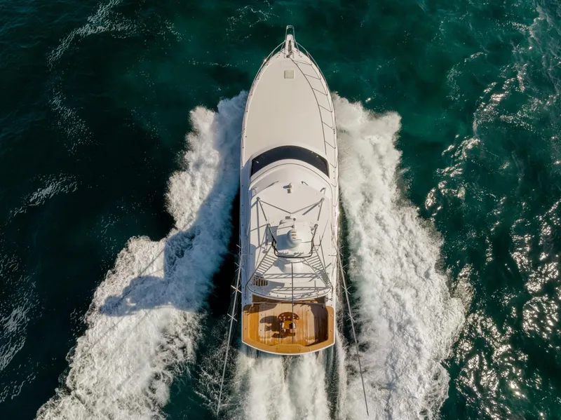 Slide: The Image of 2018 Hatteras GT70 yacht cruising on open ocean, aerial view. - 2
