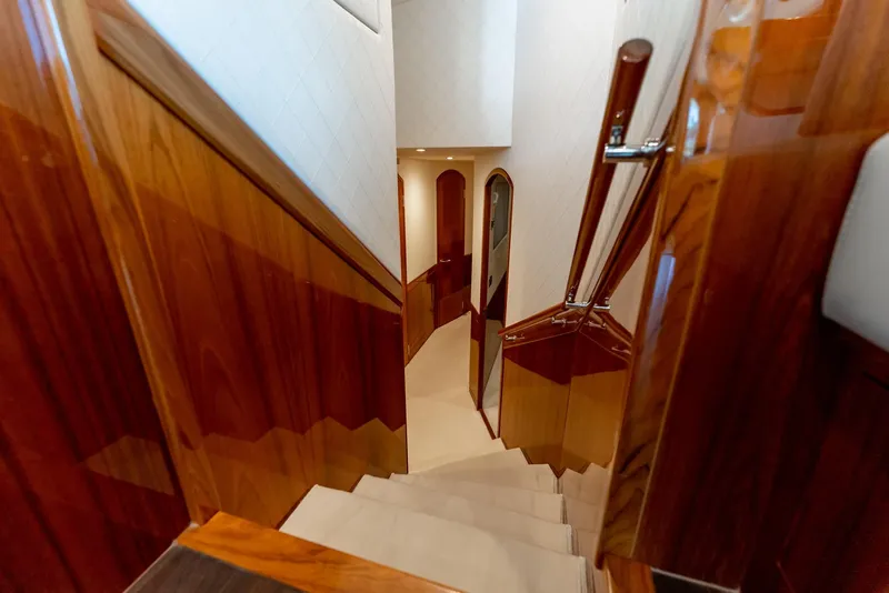 Slide: The Image of Luxurious wooden staircase inside a 2018 Hatteras GT70 yacht. - 21