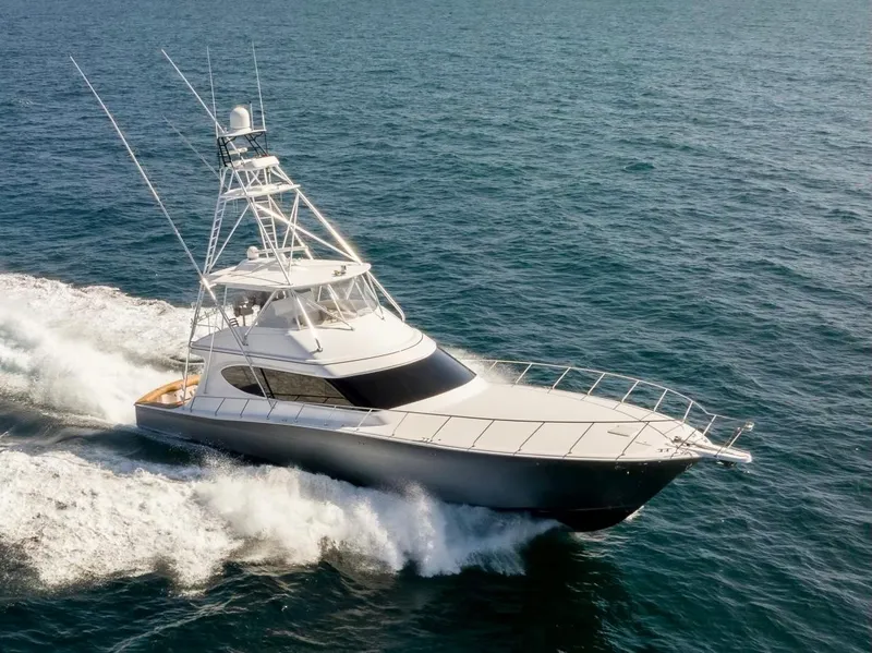 Slide: The Image of 2018 Hatteras GT70 yacht cruising on open sea, showcasing sleek design and performance. - 3