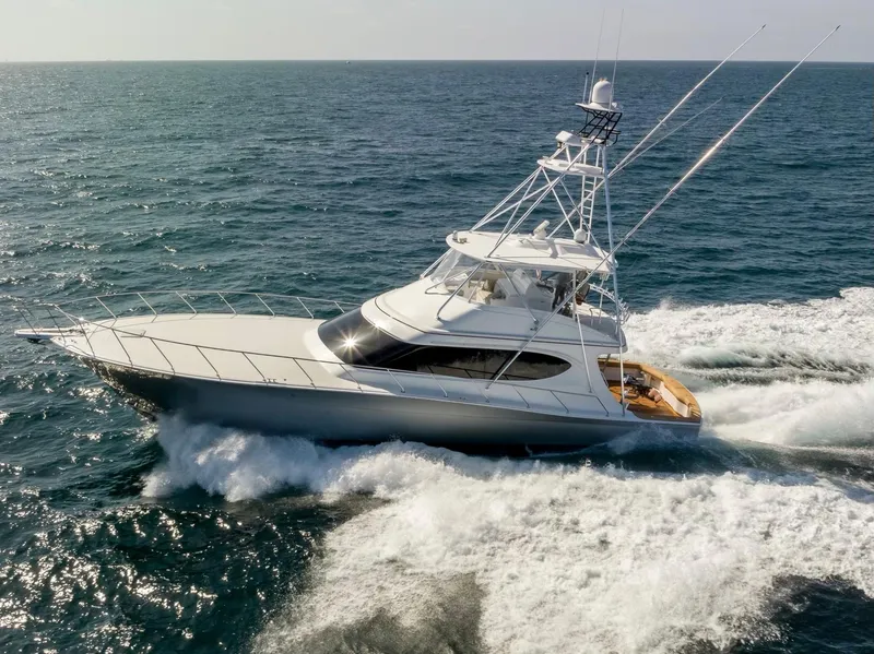 Slide: The Image of 2018 Hatteras GT70 yacht cruising on open sea, showcasing sleek design and powerful performance. - 4