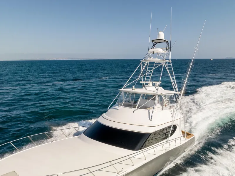 Slide: The Image of 2018 Hatteras GT70 yacht cruising on open sea under clear blue sky. - 6
