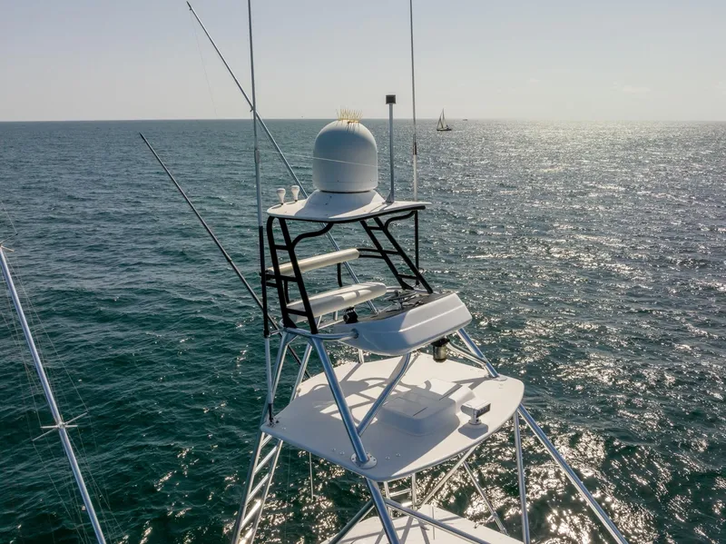 Slide: The Image of 2018 Hatteras GT70 yacht tower with ocean backdrop, showcasing radar and navigation equipment. - 7