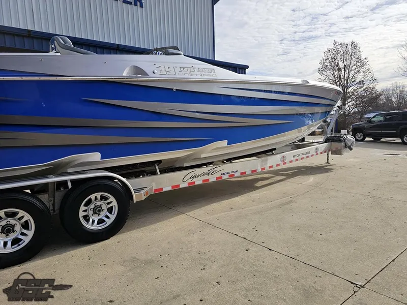 Slide: The Image of 2012 Cigarette 39' Top Gun Unlimited boat on trailer, blue and silver design. - 12