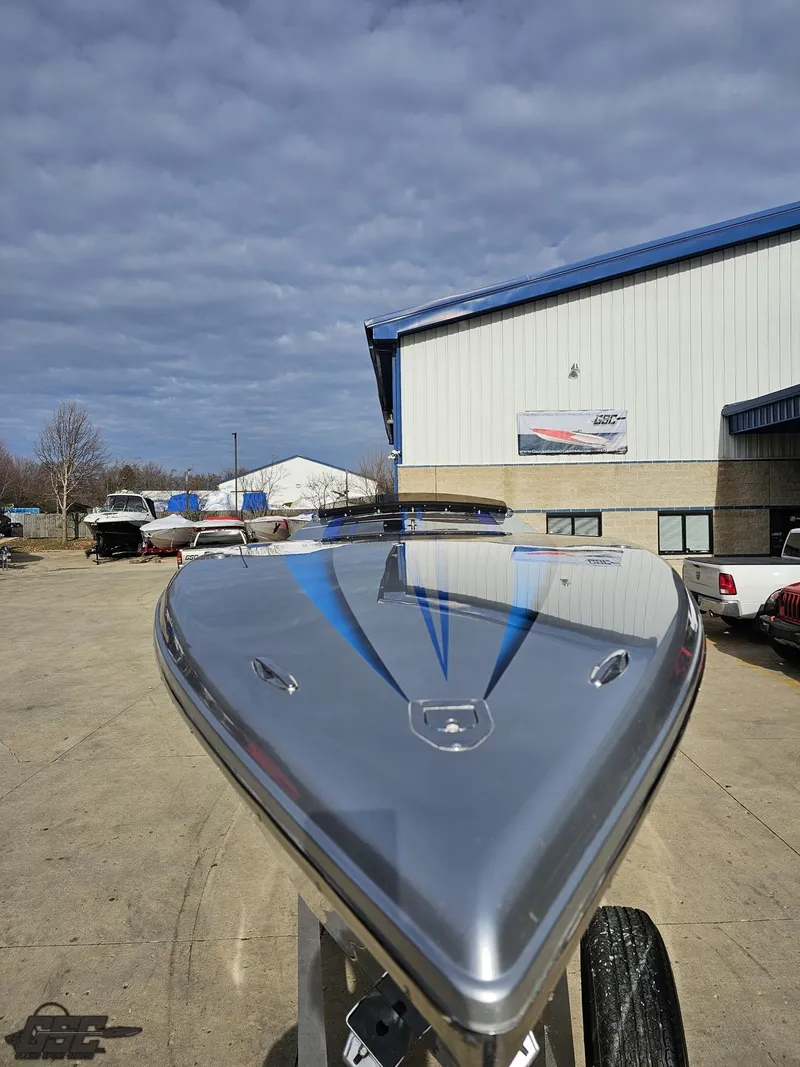 Slide: The Image of 2012 Cigarette 39' Top Gun Unlimited boat with sleek design, parked outdoors. - 16