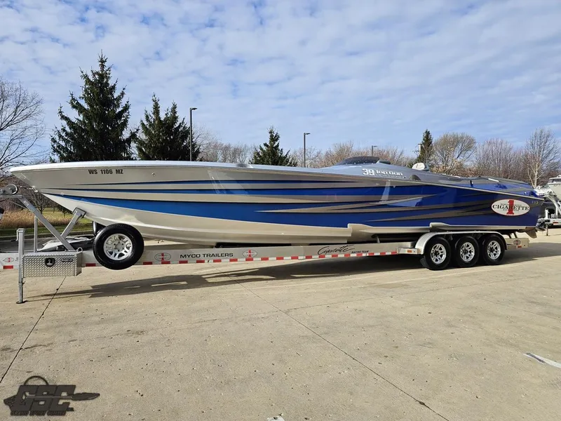 Slide: The Image of 2012 Cigarette 39' Top Gun Unlimited speedboat on trailer, blue and silver design. - 17