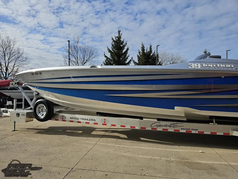 Slide: The Image of 2012 Cigarette 39' Top Gun Unlimited boat on trailer, blue and silver design. - 19