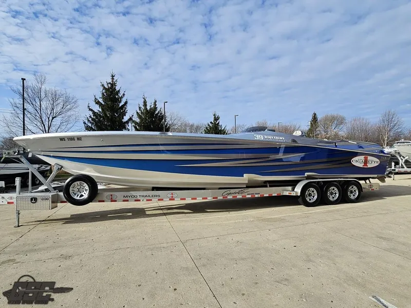 Slide: The Image of 2012 Cigarette 39' Top Gun Unlimited speedboat on trailer, blue and white design. - 20