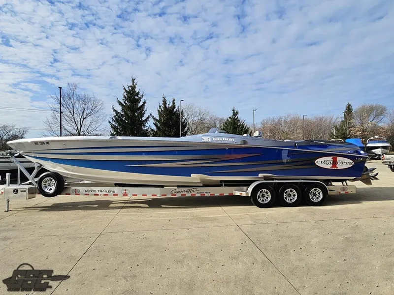 Slide: The Image of 2012 Cigarette 39' Top Gun Unlimited speedboat on trailer, blue and silver design. - 21