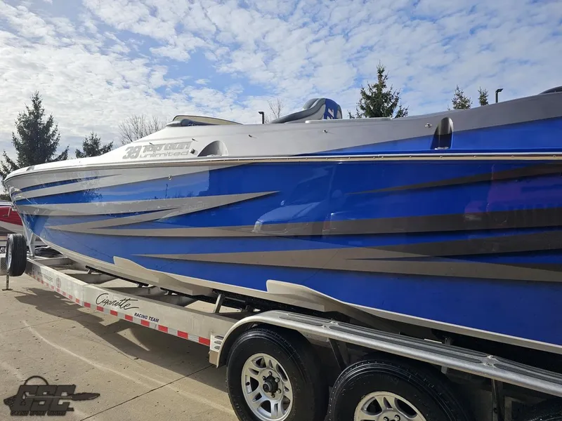 Slide: The Image of 2012 Cigarette 39' Top Gun Unlimited boat on trailer, blue and gray design. - 25