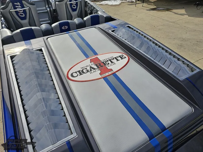 Slide: The Image of 2012 Cigarette 39' Top Gun Unlimited boat with blue stripes and logo. - 33
