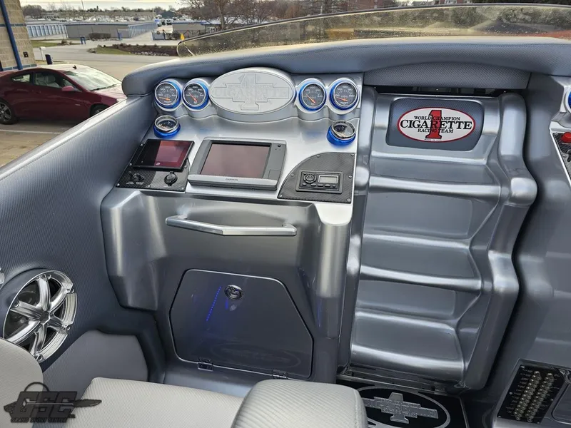 Slide: The Image of 2012 Cigarette 39' Top Gun Unlimited boat dashboard with gauges and controls. - 45