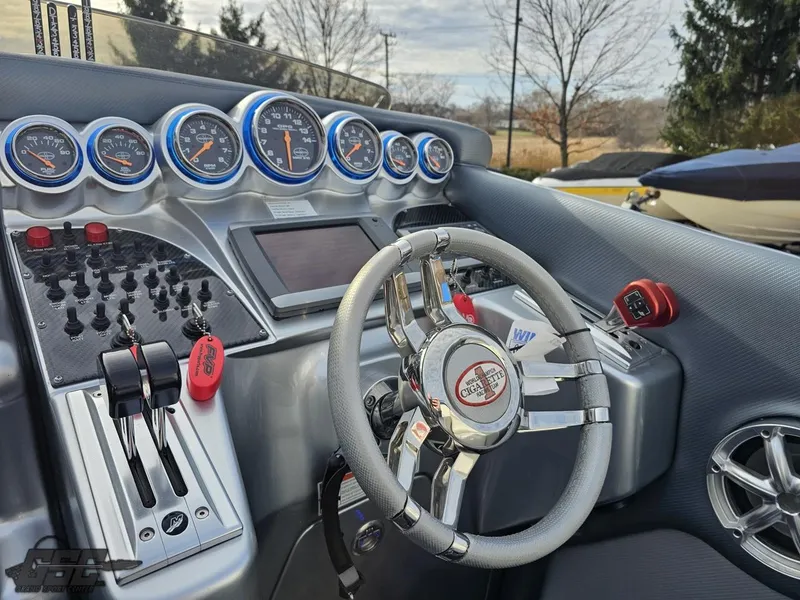 Slide: The Image of 2012 Cigarette 39' Top Gun Unlimited dashboard with gauges and steering wheel. - 49