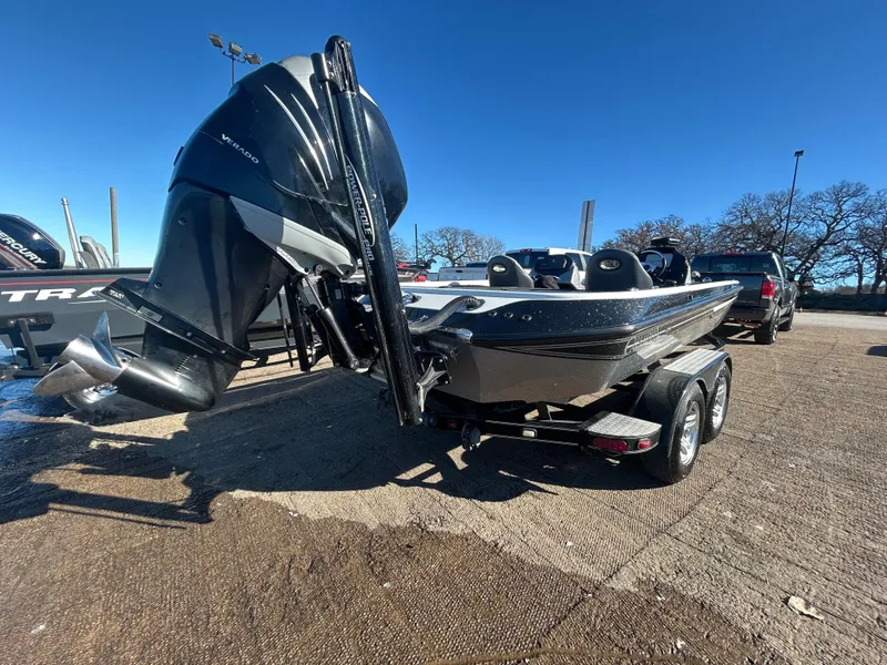 Slide: The Image of 2009 Champion 210 Elite boat on trailer by lakeside. - 11