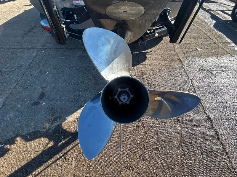 Slide: The Image of 2009 Champion 210 Elite boat trailer on a lakeside ramp. - 13