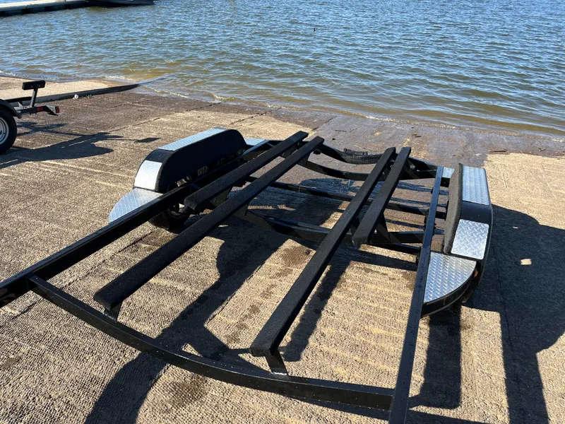 Slide: The Image of 2009 Champion 210 Elite boat on trailer, side view. - 3