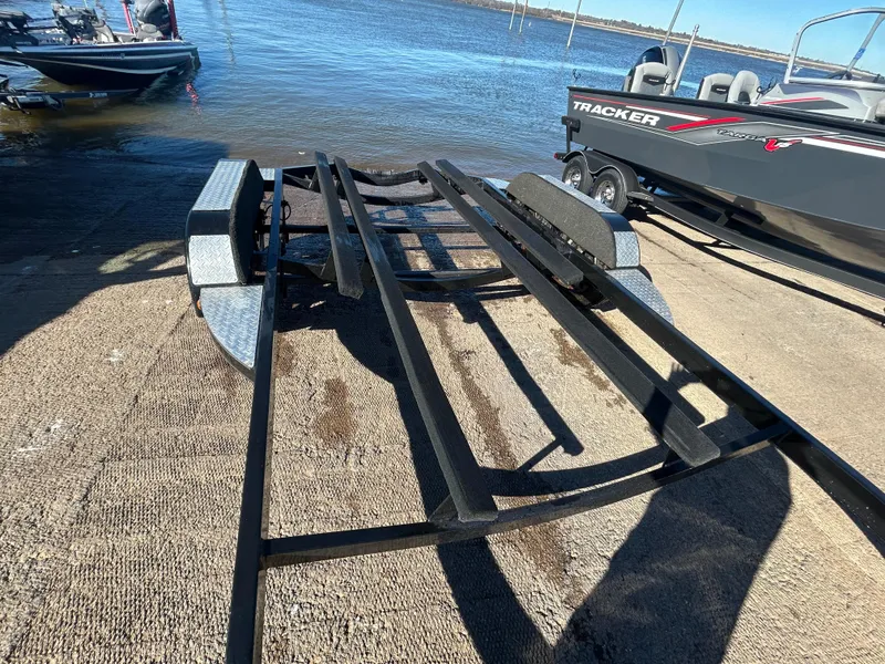 Slide: The Image of 2009 Champion 210 Elite boat trailer submerged in water at a launch ramp. - 39