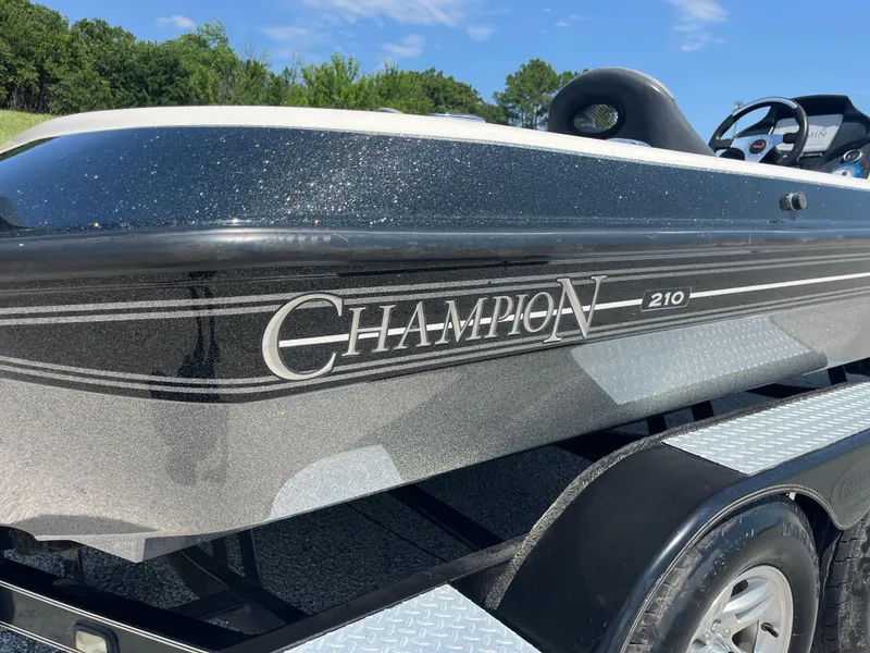 Slide: The Image of 2009 Champion 210 Elite boat trailer with diamond plate and covered spare tire. - 47