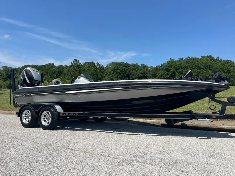 Slide: The Image of 2009 Champion 210 Elite trailer with disc brakes, parked on gravel near grass. - 51