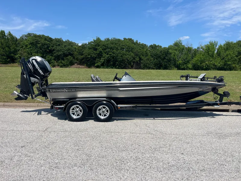 Slide: The Image of 2009 Champion 210 Elite boat on trailer, close-up view, outdoors. - 53