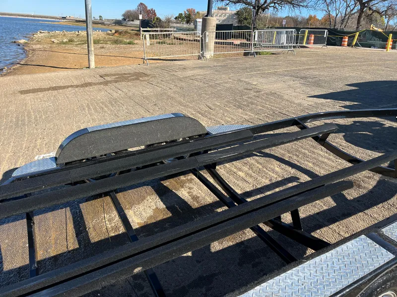 Slide: The Image of 2009 Champion 210 Elite boat with powerful outboard motor on trailer. - 6