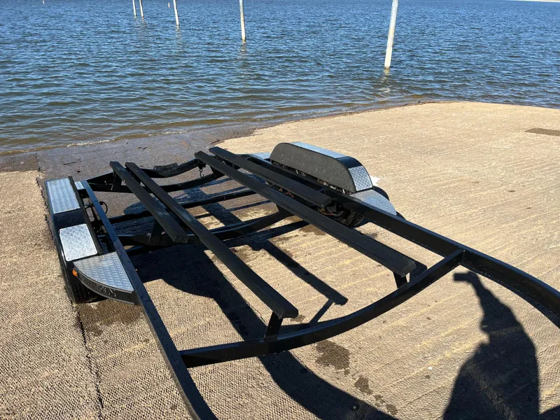 Slide: The Image of Rear view of a 2009 Champion 210 Elite boat on the street. - 7