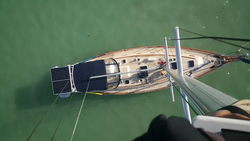 Slide: The Image of Overhead view of a 1999 Island Packet 45 sailboat on calm green water. - 1