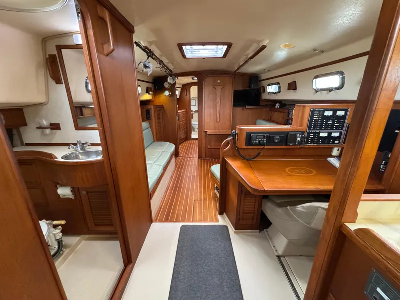 Slide: The Image of Interior of 1999 Island Packet 45 sailboat with wood finish and navigation station. - 16