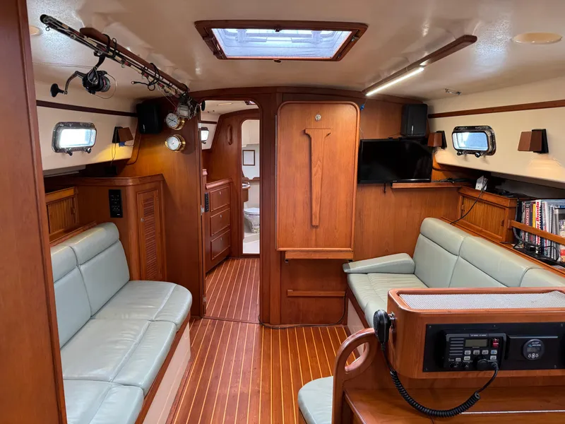 Slide: The Image of Interior of 1999 Island Packet 45 sailboat with wood finish and seating area. - 17