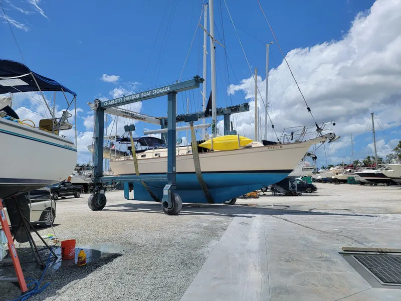 Slide: The Image of Island Packet 45 sailboat from 1999 on a boat lift at a marina. - 2