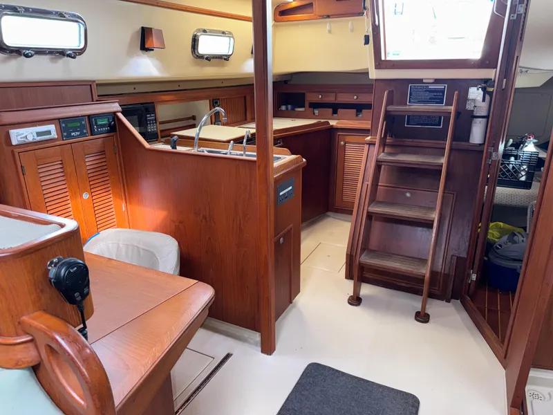 Slide: The Image of Interior of 1999 Island Packet 45 sailboat with wooden cabinetry and stairs. - 20
