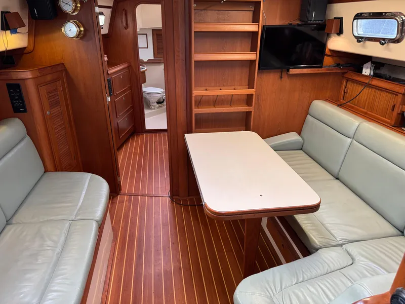 Slide: The Image of Interior of 1999 Island Packet 45 yacht with wooden flooring and comfortable seating. - 27