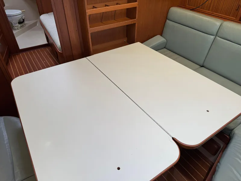 Slide: The Image of Interior of 1999 Island Packet 45 yacht with dining table and cushioned seating. - 28