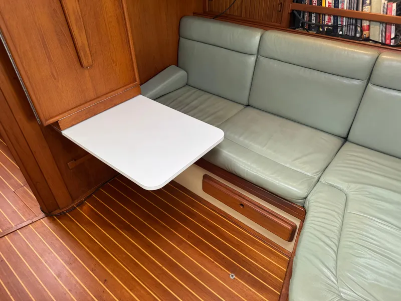 Slide: The Image of 1999 Island Packet 45 interior with green leather seating and foldable table. - 29