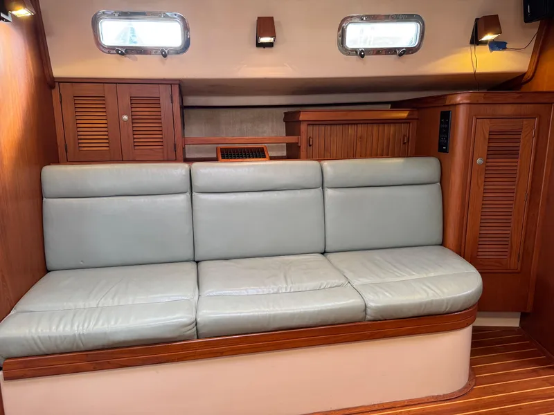 Slide: The Image of Interior of 1999 Island Packet 45 yacht with leather seating and wooden cabinetry. - 30