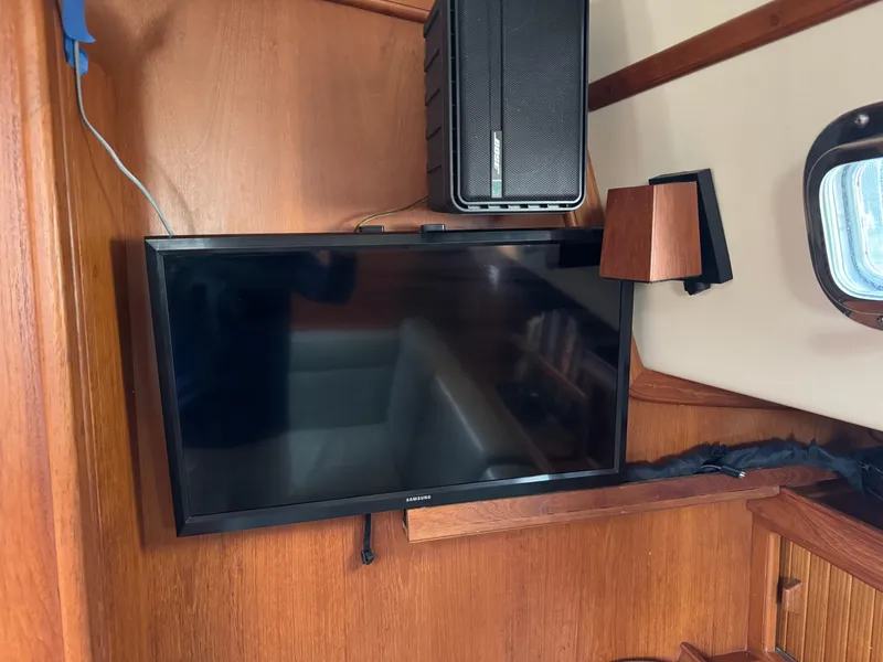 Slide: The Image of Flat-screen TV and speaker in 1999 Island Packet 45 yacht interior. - 33