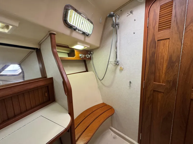 Slide: The Image of 1999 Island Packet 45 yacht bathroom with wooden accents and shower. - 39