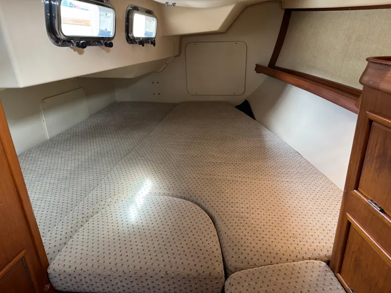 Slide: The Image of Interior cabin of 1999 Island Packet 45 sailboat with cushioned sleeping area. - 40