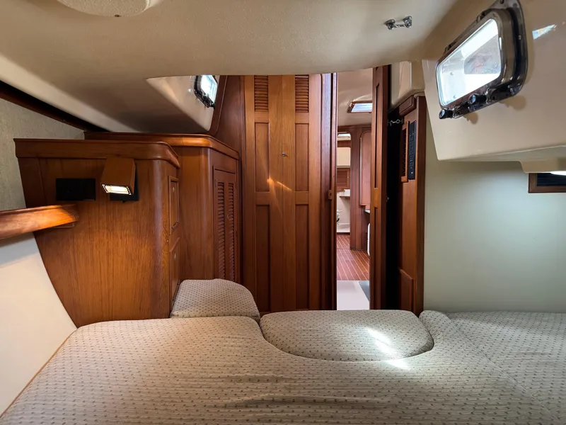 Slide: The Image of Interior cabin of 1999 Island Packet 45 sailboat with wooden finishes and cozy bedding. - 41