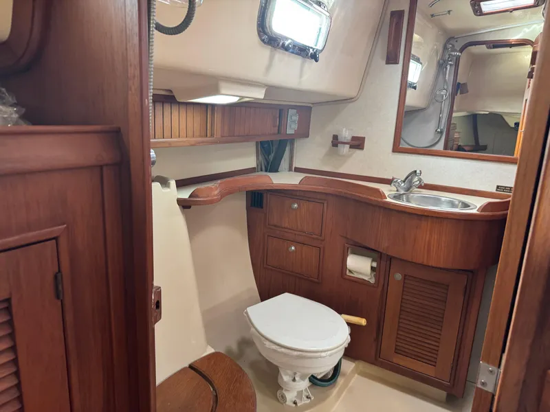 Slide: The Image of 1999 Island Packet 45 yacht bathroom with wooden cabinetry and compact design. - 43