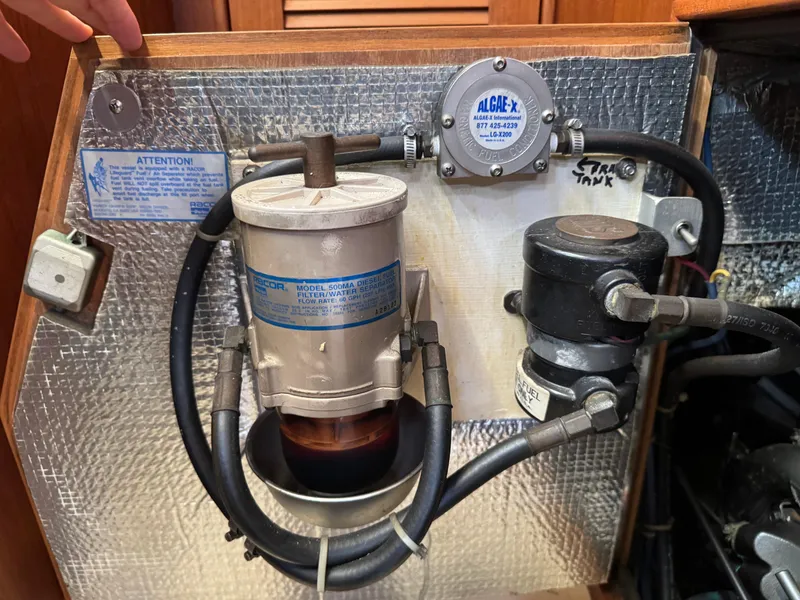 Slide: The Image of Fuel filtration system in a 1999 Island Packet 45 sailboat engine compartment. - 46