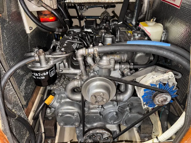 Slide: The Image of Engine compartment of a 1999 Island Packet 45 sailboat, showcasing mechanical components and fuel filter. - 48