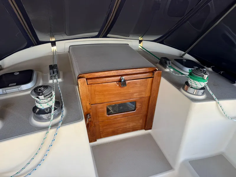 Slide: The Image of 1999 Island Packet 45 sailboat cockpit with winches and wooden hatch. - 7