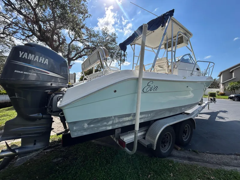 Slide: The Image of 2004 Cobia 250 Walk-Around boat on trailer with Yamaha outboard motor. - 10