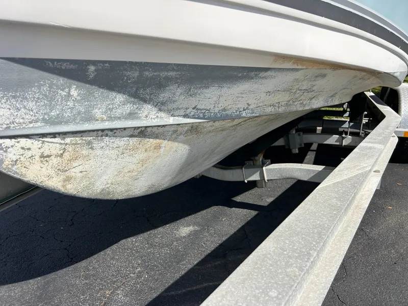 Slide: The Image of 2004 Cobia 250 Walk-Around boat hull on trailer, showing underside details. - 15