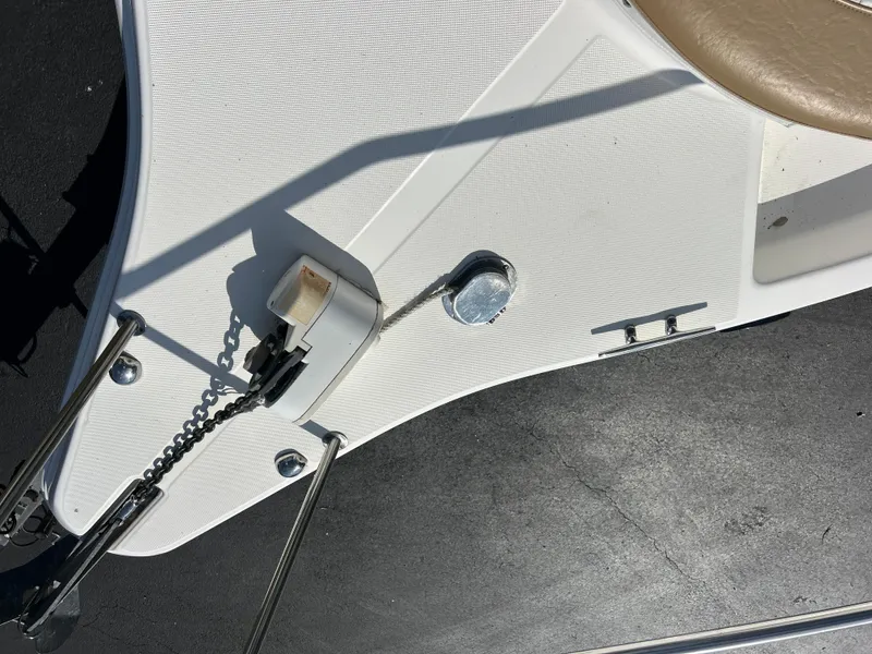 Slide: The Image of 2004 Cobia 250 Walk-Around boat deck with anchor chain and cleat. - 20