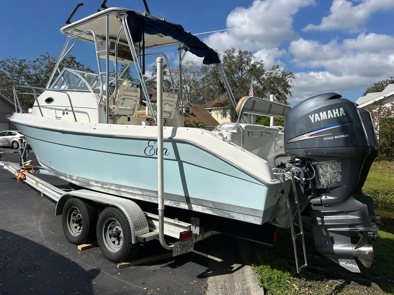 Slide: The Image of 2004 Cobia 250 Walk-Around boat on trailer with Yamaha outboard motor. - 8