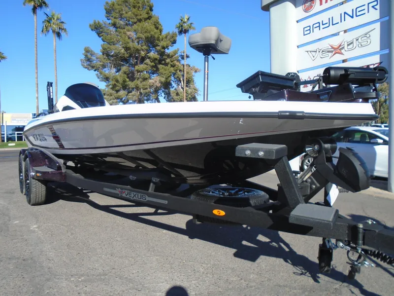 Slide: The Image of 2025 Vexus VXS20 boat on trailer, parked outdoors under clear sky. - 21