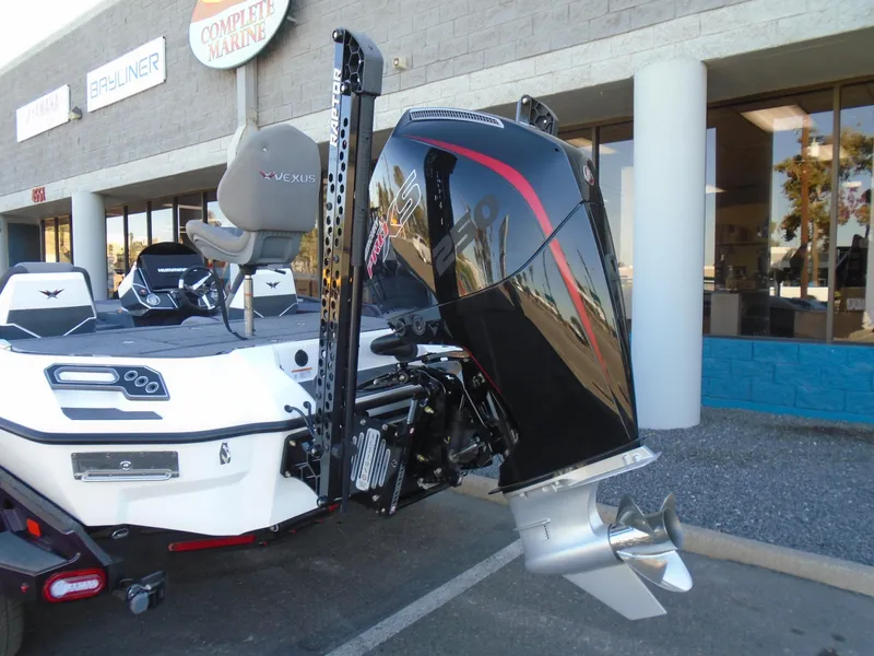 Slide: The Image of 2025 Vexus VXS20 boat with powerful outboard motor, parked outside a marine store. - 5