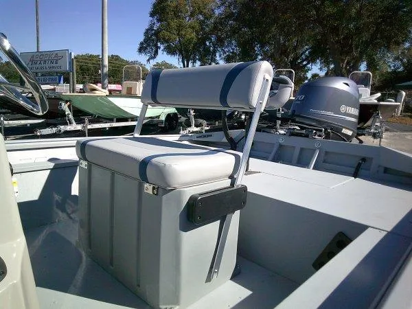 Slide: The Image of 2025 G3 18CCTDLX boat interior with seating and Yamaha motor in a marina setting. - 3